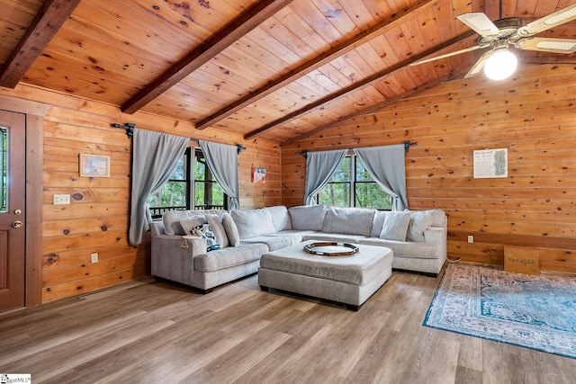 living room with wood ceiling, light wood-style floors, wood walls, and a ceiling fan