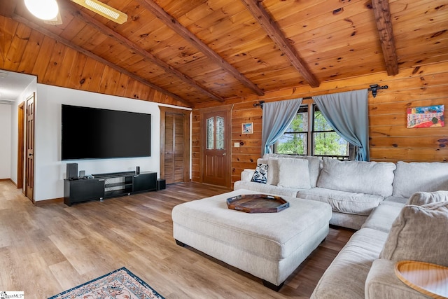 living room with wood ceiling, light wood-style flooring, wooden walls, a ceiling fan, and baseboards