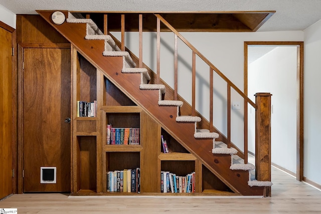 stairway featuring wood finished floors