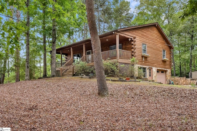 view of front of property with log siding and a garage