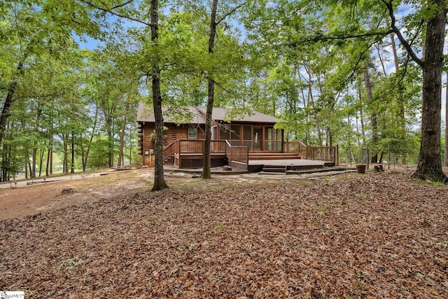 back of house featuring a sunroom and a deck