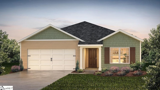 craftsman-style home featuring concrete driveway, an attached garage, a shingled roof, and a front yard