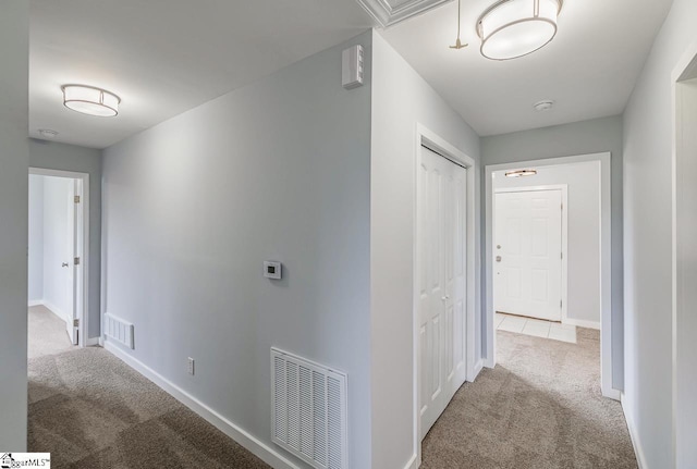 corridor with carpet and baseboards