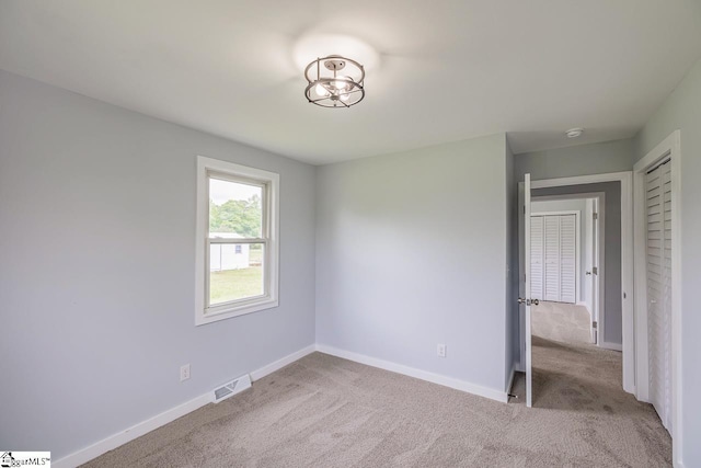unfurnished bedroom with carpet and baseboards