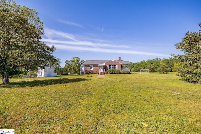 ranch-style home featuring a chimney, a shed, an outbuilding, a sport area, and brick siding
