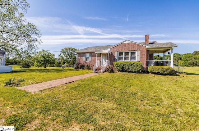 bungalow-style home featuring a chimney, a front yard, and brick siding
