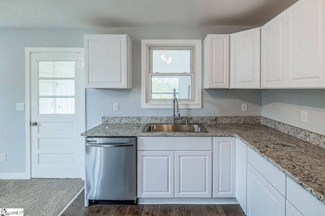 kitchen with stainless steel dishwasher, a sink, dark wood finished floors, and white cabinets