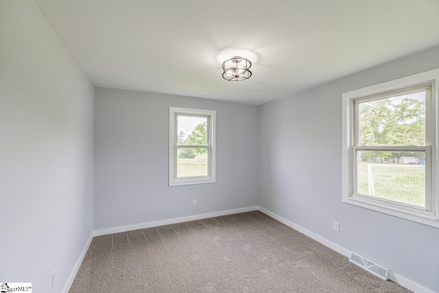 empty room with carpet flooring and baseboards