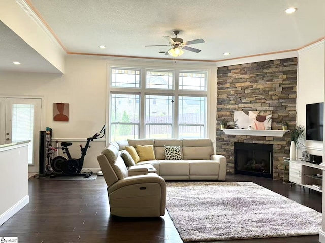 920 Hunterdale Ln, Boiling Springs, SC 29316 - living room featuring ceiling fan, crown molding, dark wood-type flooring, a stone fireplace, and baseboards