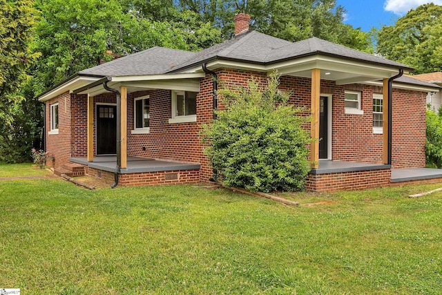 3902 Old Buncombe Rd, Greenville, SC 29617 - back of house featuring a chimney, covered porch, a yard, brick siding, and a shingled roof