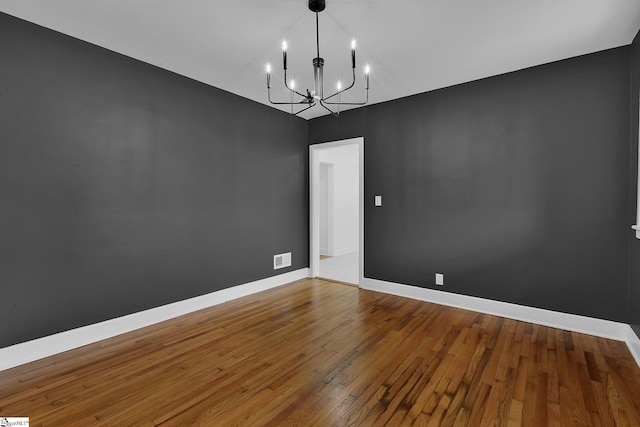 3902 Old Buncombe Rd, Greenville, SC 29617 - empty room with a chandelier, hardwood / wood-style flooring, and baseboards
