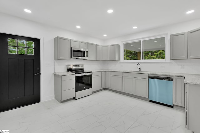 3902 Old Buncombe Rd, Greenville, SC 29617 - kitchen with appliances with stainless steel finishes, gray cabinetry, a sink, light marble finish flooring, and recessed lighting