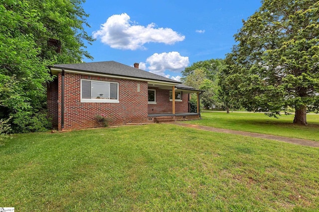 3902 Old Buncombe Rd, Greenville, SC 29617 - view of front of property with a front yard, brick siding, and a chimney