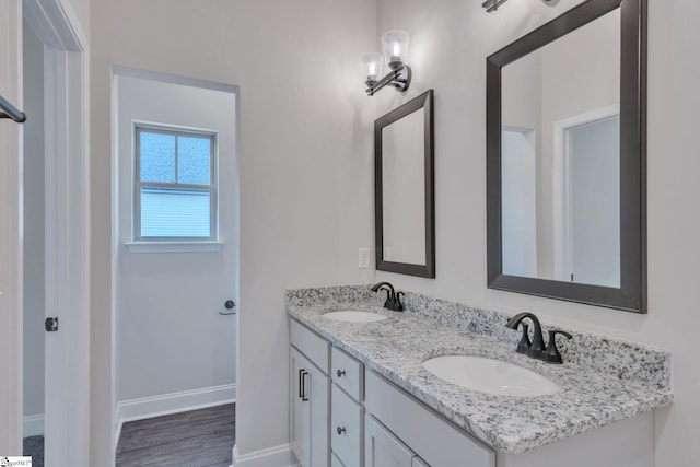 113 N Spencer St, Duncan, SC 29334 - bathroom featuring baseboards, double vanity, and wood finished floors