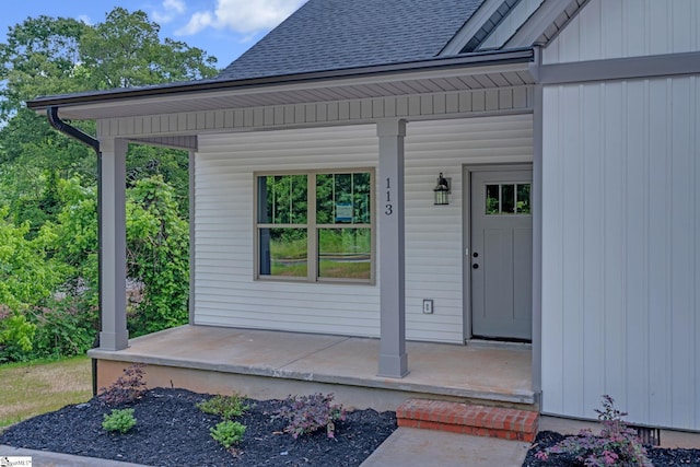 113 N Spencer St, Duncan, SC 29334 - view of exterior entry featuring a porch, a shingled roof, and board and batten siding