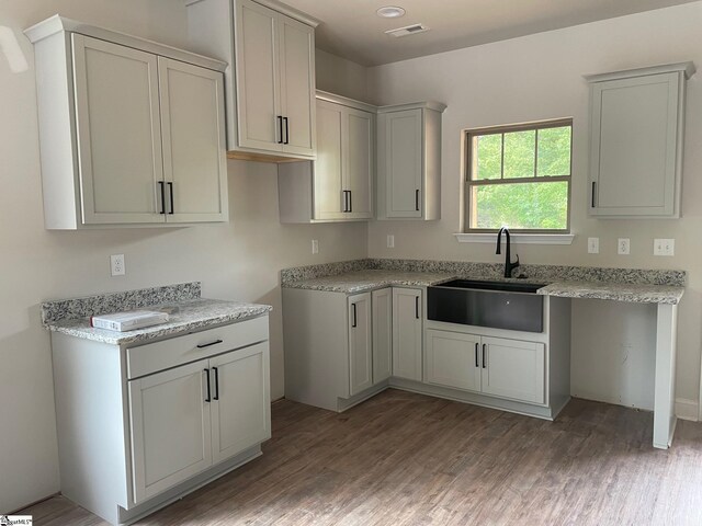 kitchen featuring a sink and light wood-style flooring