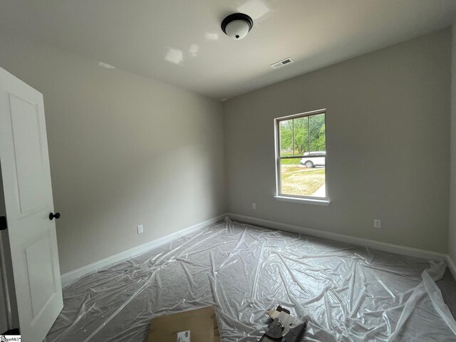 unfurnished room featuring baseboards