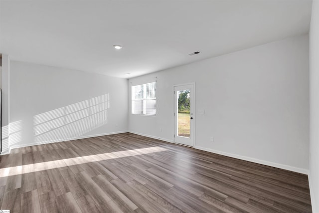 unfurnished room with wood finished floors and baseboards