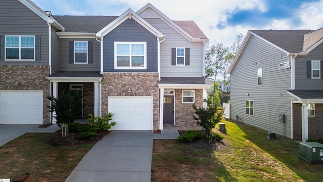 view of front facade featuring brick siding, driveway, and an attached garage