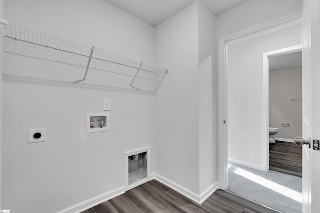 laundry room featuring electric dryer hookup, hookup for a washing machine, dark wood finished floors, and baseboards