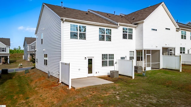 rear view of property with central AC unit, a patio area, and a shingled roof