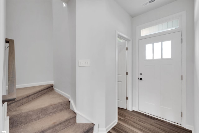 foyer featuring stairway, baseboards, and dark wood-style flooring