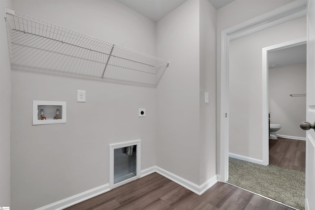 washroom with electric dryer hookup, washer hookup, dark wood finished floors, and baseboards