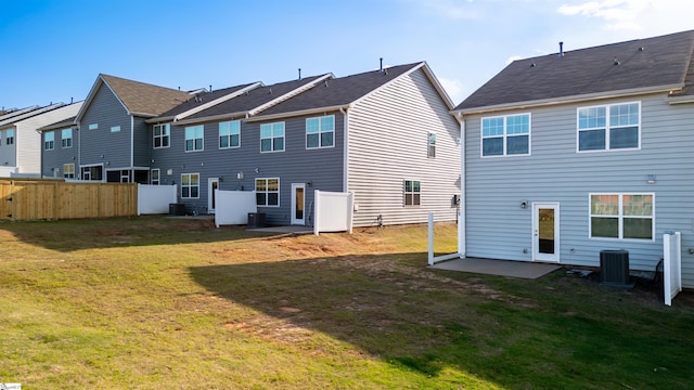 back of property with central AC unit, a patio area, and a residential view