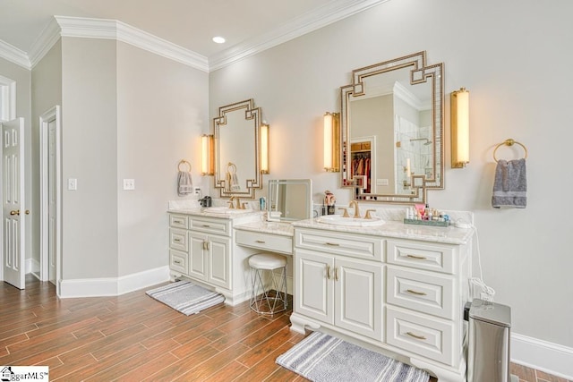 bathroom with vanity, wood finished floors, baseboards, ornamental molding, and recessed lighting