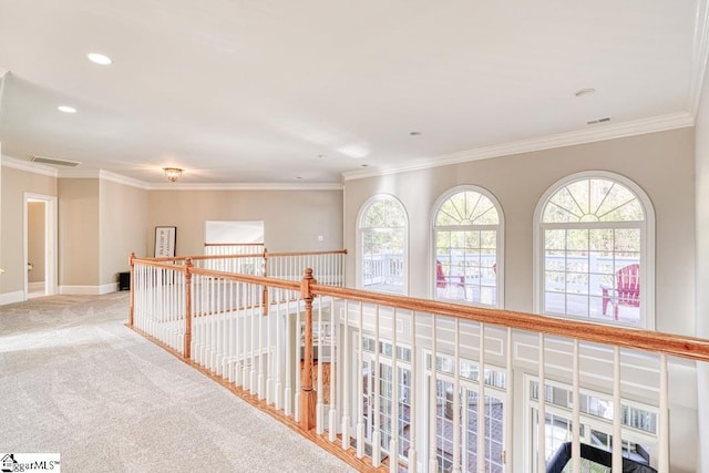 hall featuring carpet floors, healthy amount of natural light, ornamental molding, recessed lighting, and baseboards