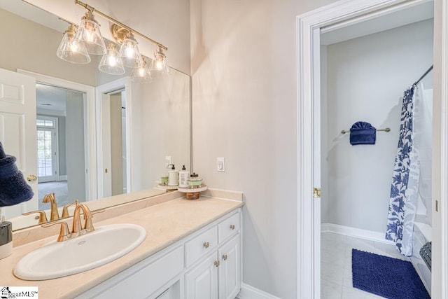 full bath with vanity, baseboards, and a shower with shower curtain