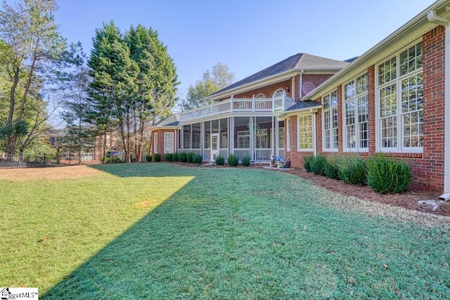 back of house with a lawn and brick siding