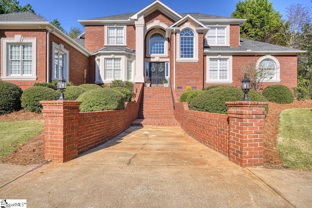 traditional home featuring brick siding