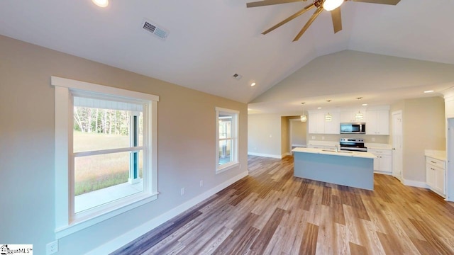 1306 Fairview Rd, Gaffney, SC 29341 - kitchen with appliances with stainless steel finishes, ceiling fan, lofted ceiling, recessed lighting, and an island with sink
