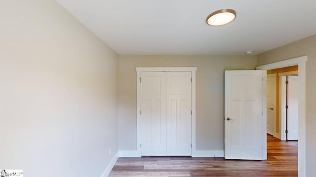 1306 Fairview Rd, Gaffney, SC 29341 - unfurnished bedroom with wood finished floors, a closet, and baseboards