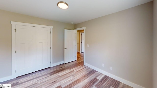 1306 Fairview Rd, Gaffney, SC 29341 - unfurnished bedroom featuring baseboards, light wood finished floors, and a closet