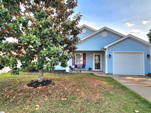 view of front of home with a garage, concrete driveway, and covered porch