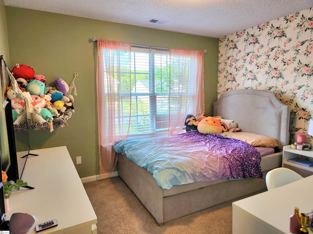 bedroom with a textured ceiling, light carpet, and baseboards