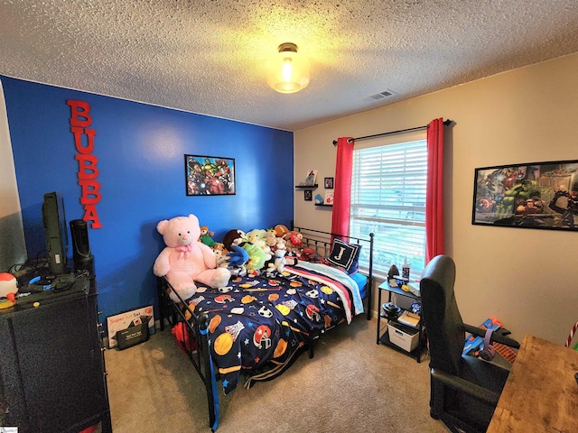 bedroom featuring carpet floors and a textured ceiling