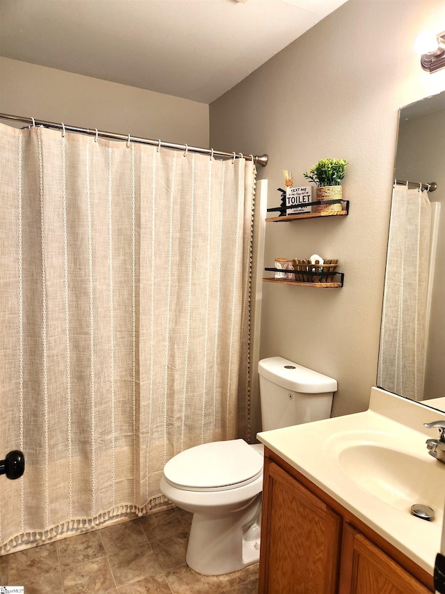 bathroom featuring toilet and vanity