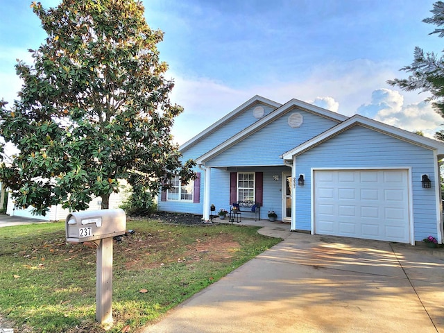 view of front facade with an attached garage, concrete driveway, and a front yard