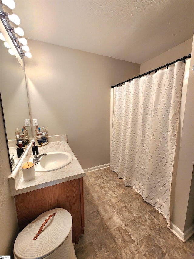 full bathroom with baseboards and vanity