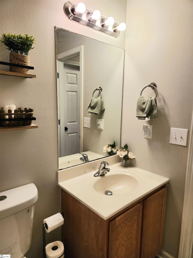 bathroom featuring vanity and toilet