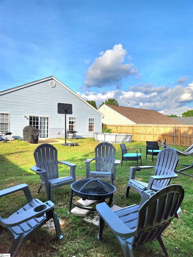 view of yard featuring an outdoor fire pit