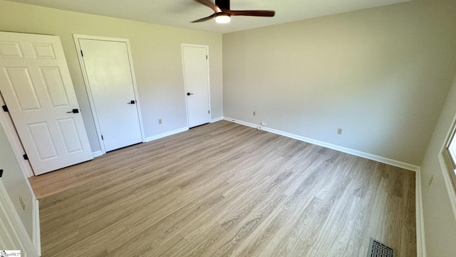 unfurnished bedroom with light wood-type flooring and baseboards