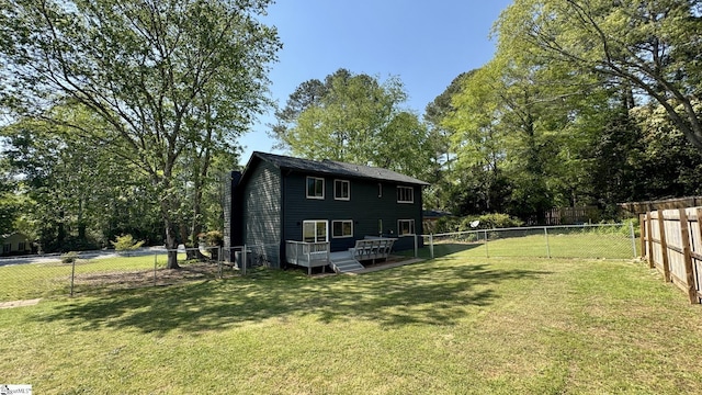 back of house with a deck and a chimney