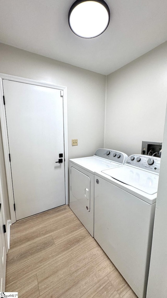 washroom featuring separate washer and dryer and light wood-type flooring