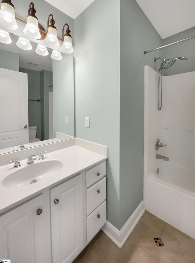bathroom featuring tile patterned flooring,  shower combination, vanity, toilet, and baseboards
