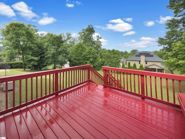 wooden terrace featuring a yard