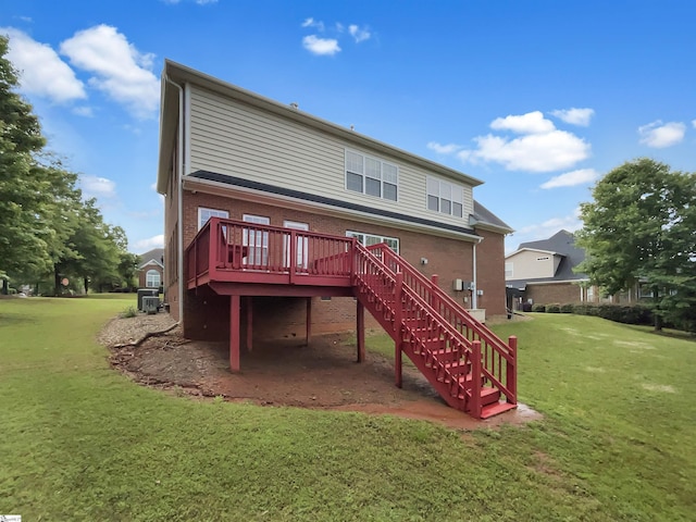 rear view of house with stairway, a wooden deck, a yard, and brick siding
